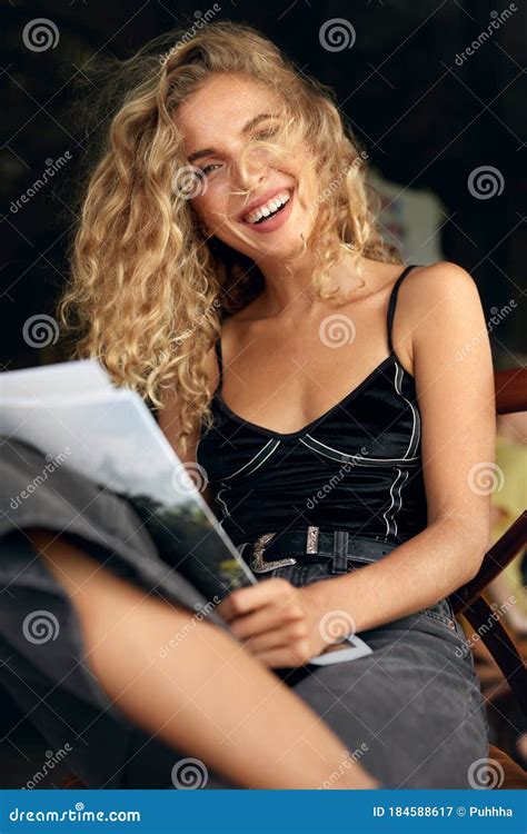 Woman Portrait Beautiful Curly Blonde Model Resting On Chair In Cafe