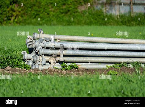 A Stack Of Round Metal Irrigation Pipes On A Farm Stock Photo Alamy