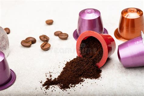 Espresso Coffee Capsules Or Pods And Coffee Beans On Grey Background