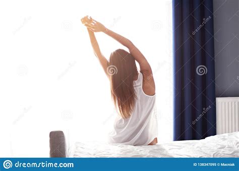 Young Beautiful Woman Waking Up In Her Bed Fully Rested Stock Image