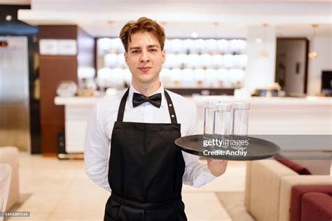 Waiter Serving Water In A Hotel Lobby High Res Stock Photo Getty Images