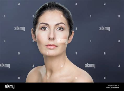 Close Up Portrait Of Topless Mature Woman Over Gray Background Stock