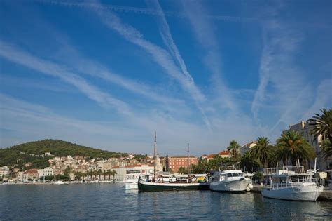 Premium Photo Sailboats Moored On Sea Against Buildings In City