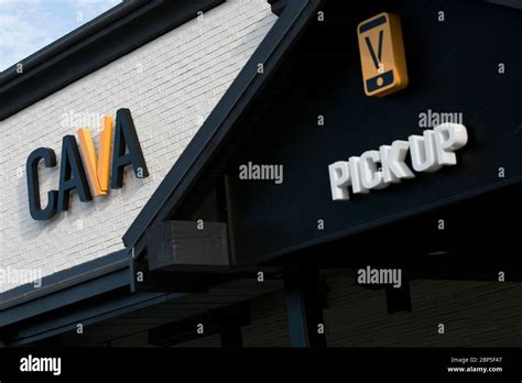 A logo sign outside of a Cava restaurant location in Richmond, Virginia ...