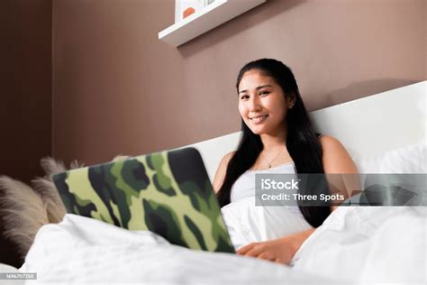 Photo From Side Kazachstan Asian Girl Laying On Bed Delightfully Looking At Camera With