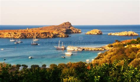 Boats In The Golden Afternoon Light On The Rocky Bay Of Lindos On Sunny