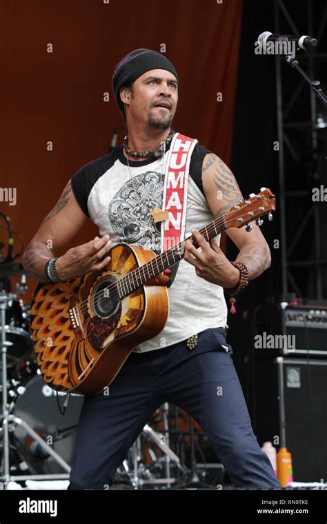 Michael Franti Is Shown Performing On Stage During A Live Concert