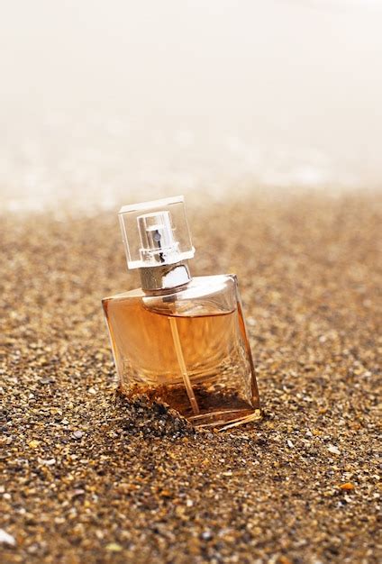 Premium Photo A Bottle Of Perfume In The Sand By The Sea Yellow Sand