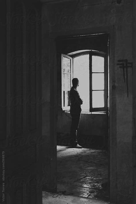 Man In Front Of An Open Window In An Abandoned Room By Stocksy Contributor Victor Torres