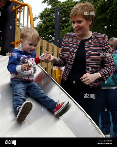 First Minister Nicola Sturgeon Helps Jamie Mcguiness Down A Slide As