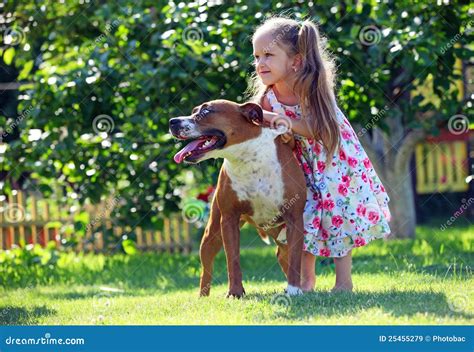 Cute Four-year Old Girl Playing With A Dog Royalty-Free Stock Photo ...