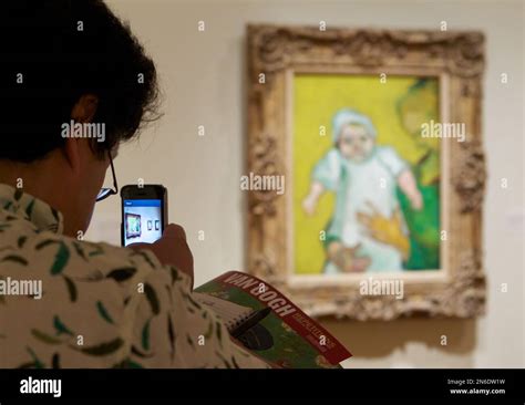 A Member Of The Media Photographs A Vincent Van Gogh Piece On Display