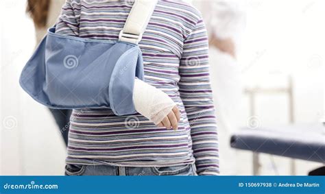 Girl With Broken Arm And Arm Brace In The Doctor`s Office Stock Photo