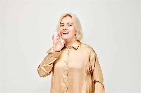 Premium Photo Portrait Of Blonde Girl Shouting Loudly With Hands News Palms Folded Like
