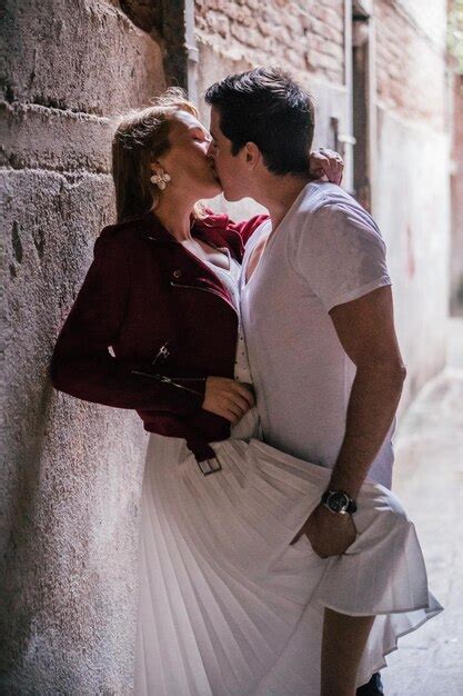 Premium Photo Couple Kissing Against Wall