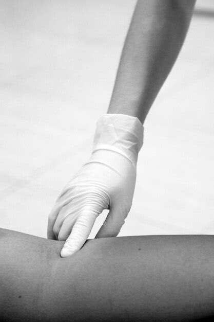 Premium Photo Cropped Hand Of Doctor Examining Patient