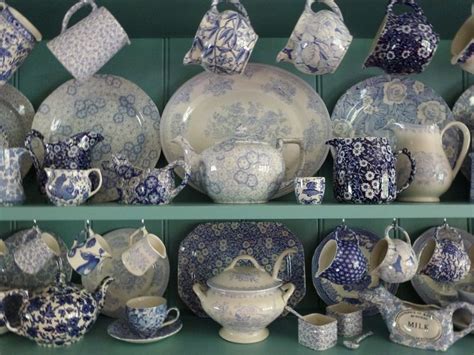 blue and white china on display in a store