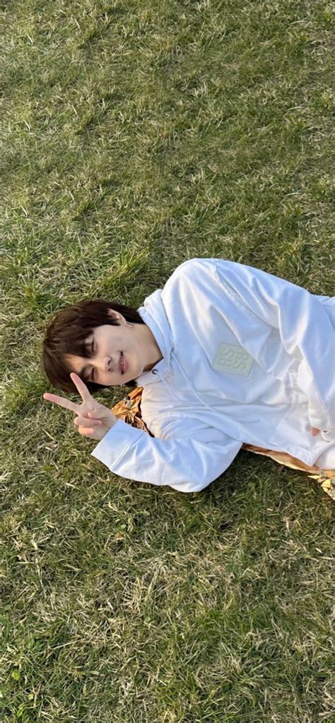 A Woman Laying On The Ground With Her Hand Up