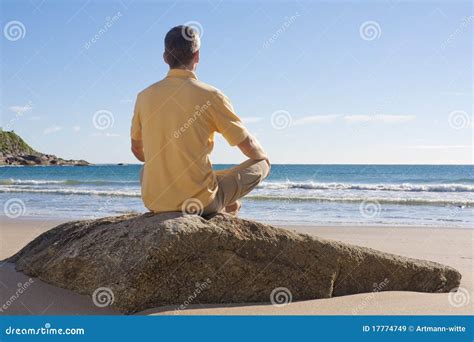 Man Meditating On A Beach Stock Image Image Of Serene