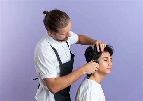 Free Photo Young Handsome Barber Wearing Uniform Standing In Profile