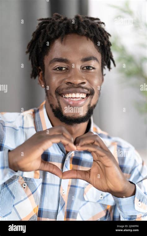 Handsome Guy in Plaid Casual Shirt Shows Heart Gesture by his Fingers ...