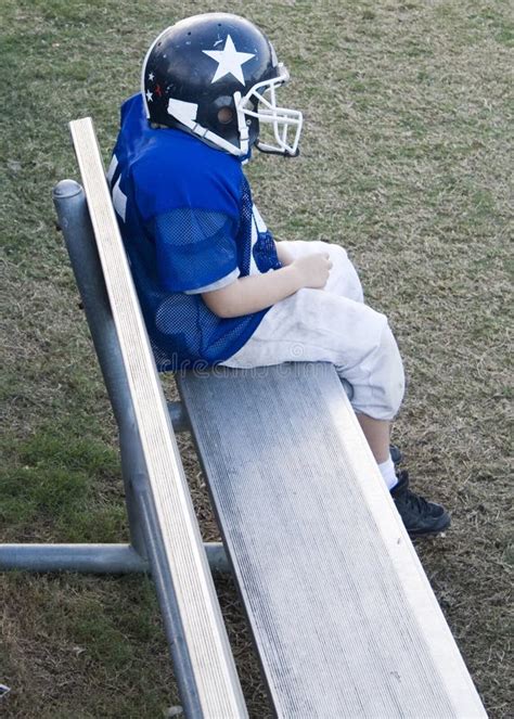 Youth Football Player Alone on the Bench Stock Image - Image of child ...