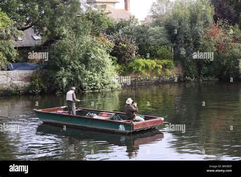 Two Men In A Flat Bottomed Boat On The River Avon In Christchurch