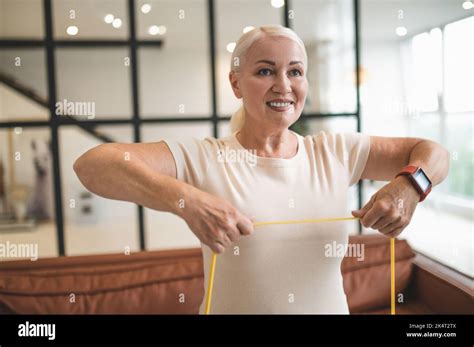 Cheerful Blonde Lady Doing An Upper Body Exercise Stock Photo Alamy