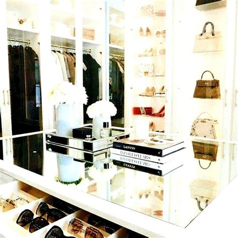 A White Closet Filled With Lots Of Shoes And Handbags Next To A Large