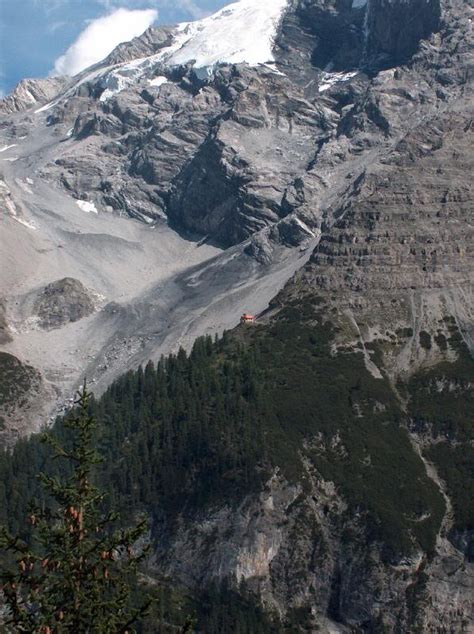 The Mountain Is Covered In Snow And Trees