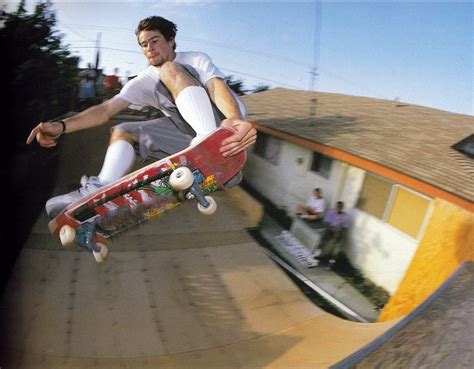 A Man Riding A Skateboard Up The Side Of A Ramp