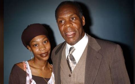 an older man and young woman posing for a photo