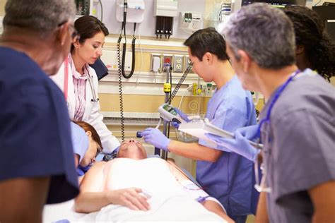 Medical Team Working On Patient In Emergency Room Stock Image - Image ...