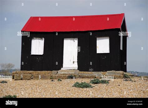 Black hut with red roof at Rye Harbour beach, East Sussex Stock Photo - Alamy