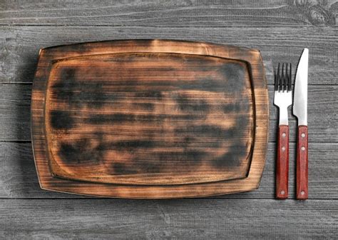 Premium Photo | Wooden plate and cutlery set on table