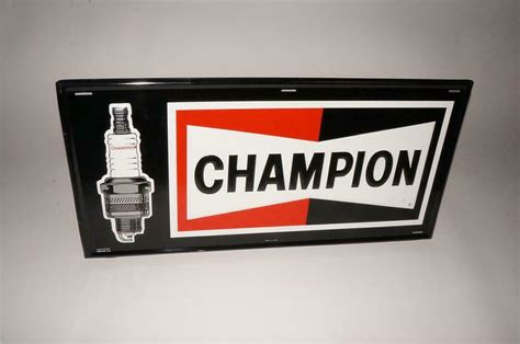 Unusual version N.O.S. Champion Spark Plugs embossed tin sign