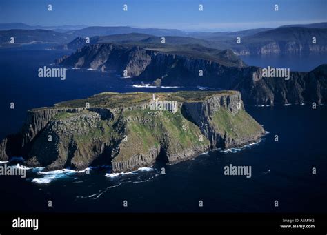 Tasman Island and lighthouse Cape Pillar behind Tasman Peninsula ...