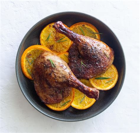 Premium Photo Baked Duck Legs With Oranges And Rosemary Rustic Style