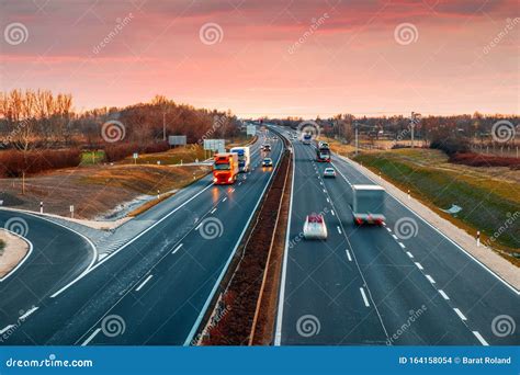 Busy Highway With Fast Moving Vehicles In Beautiful Sunset Stock Photo