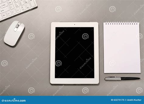 White Tablet Computer On Office Desk With A Notebook Stock Image