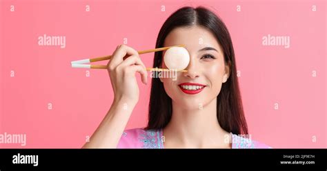 Beautiful Young Woman With Tasty Japanese Mochi On Pink Background