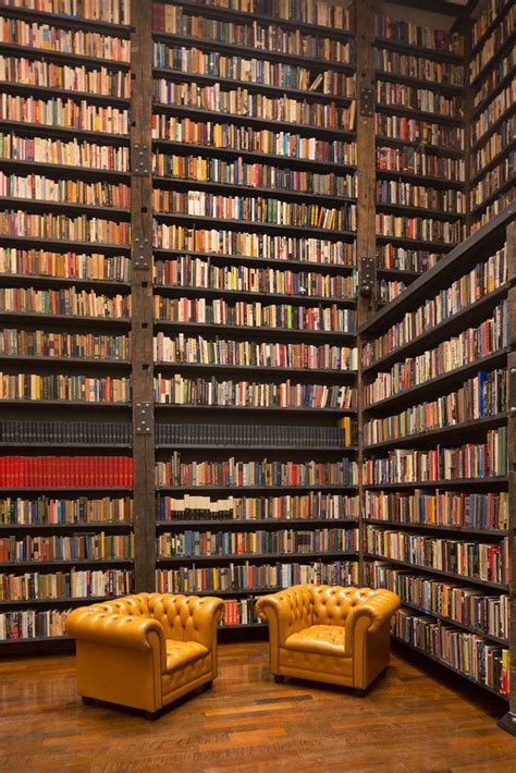 Cozy Home Library with Yellow Leather Chairs