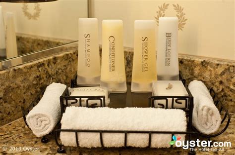 Towels And Soaps Are Sitting On A Towel Rack In Front Of A Bathroom Mirror