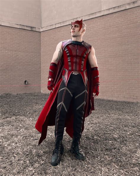 A Man Dressed In Red And Black Is Standing Outside