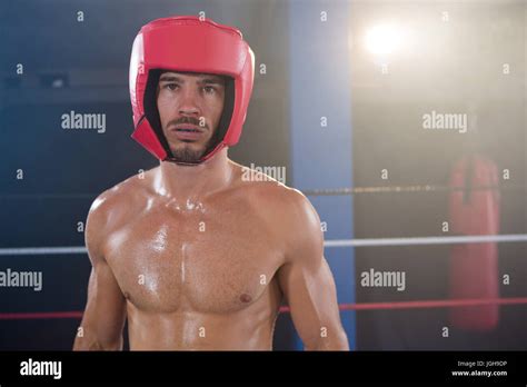 Portrait Of Shirtless Male Boxer Wearing Red Headgear In Boxing Ring