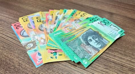 Premium Photo | Many notes of australian currency on wooden surface ...