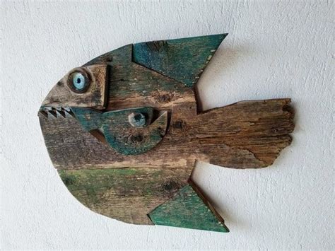 A Fish Made Out Of Wood With Blue Eyes