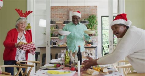 Happy Group Of Diverse Senior Friends Celebrating Meal At Christmas