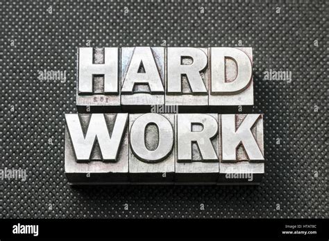 Hard Work Phrase Made From Metallic Letterpress Blocks On Black