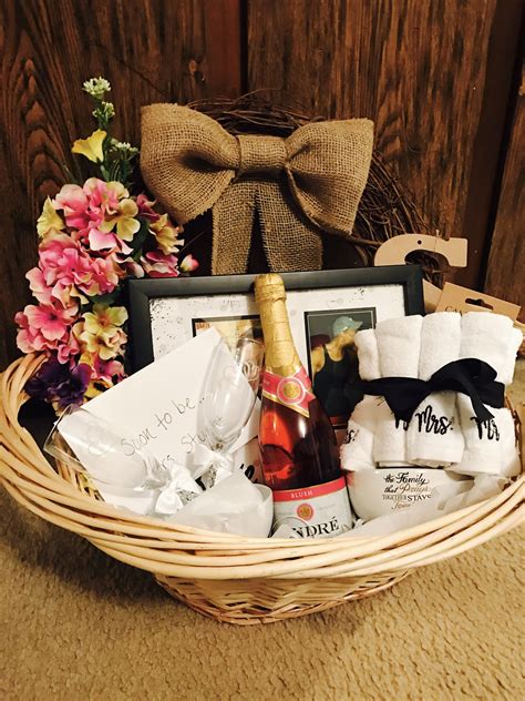 A Wicker Basket Filled With Wine And Personalized Items For Someones Special Occasion